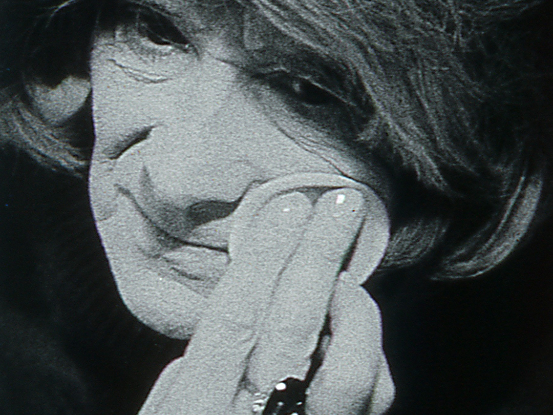 Black-and-white close-up of a person resting their face against their hand, from All Women Are Equal.
